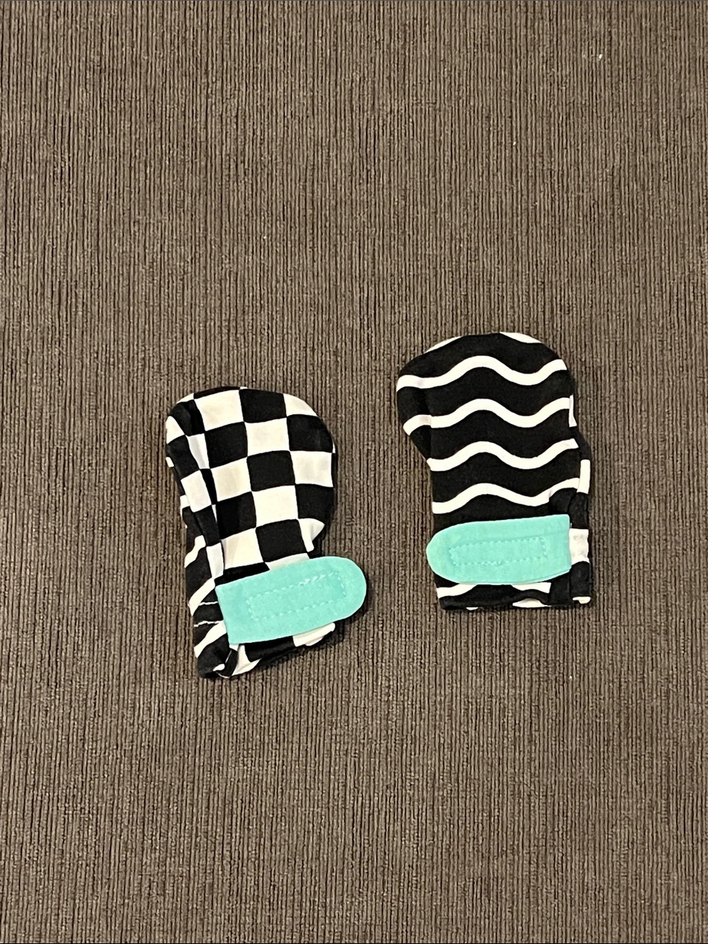 Lovevery Baby Black & White Patterned Mittens with Teal Strap Like New